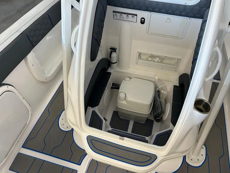 Slide: The Image of 2024 Glasstream 28 GSX Pro cabin interior with seating and portable toilet. - 23