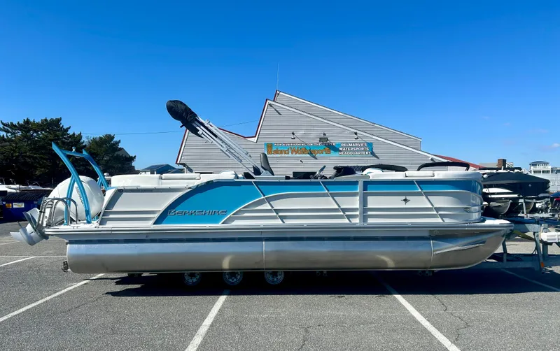 Slide: The Image of 2025 Berkshire 23RFX STS 3.0 pontoon boat parked outdoors on a sunny day. - 0