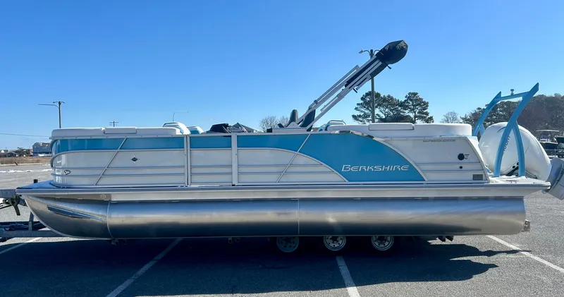 Slide: The Image of 2025 Berkshire 23RFX STS 3.0 pontoon boat in a parking lot. - 2