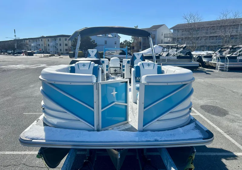 Slide: The Image of 2025 Berkshire 23RFX STS 3.0 pontoon boat in a parking lot, rear view. - 3