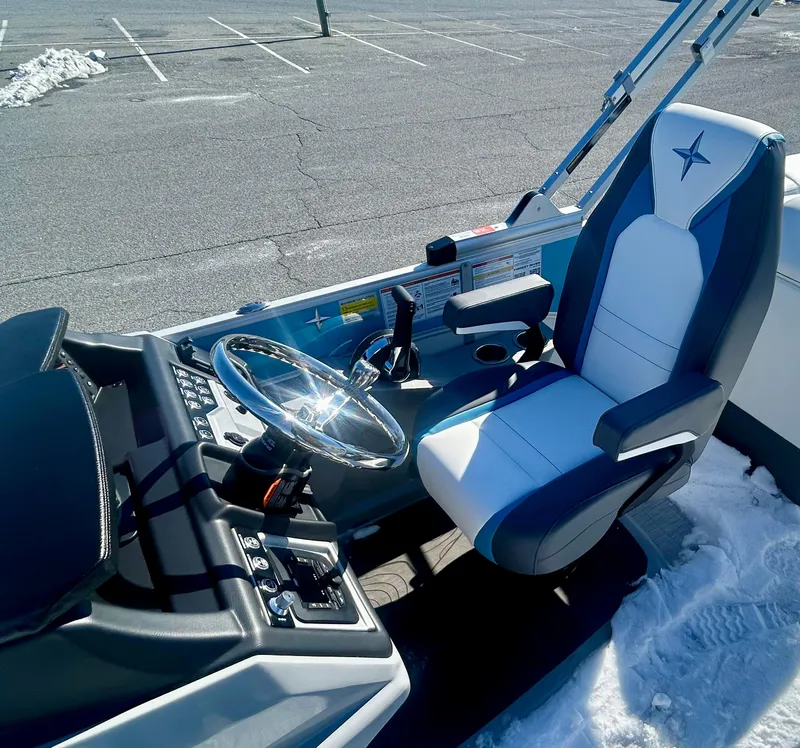 Slide: The Image of 2025 Berkshire 23RFX STS 3.0 boat interior with steering wheel and captain's chair. - 7