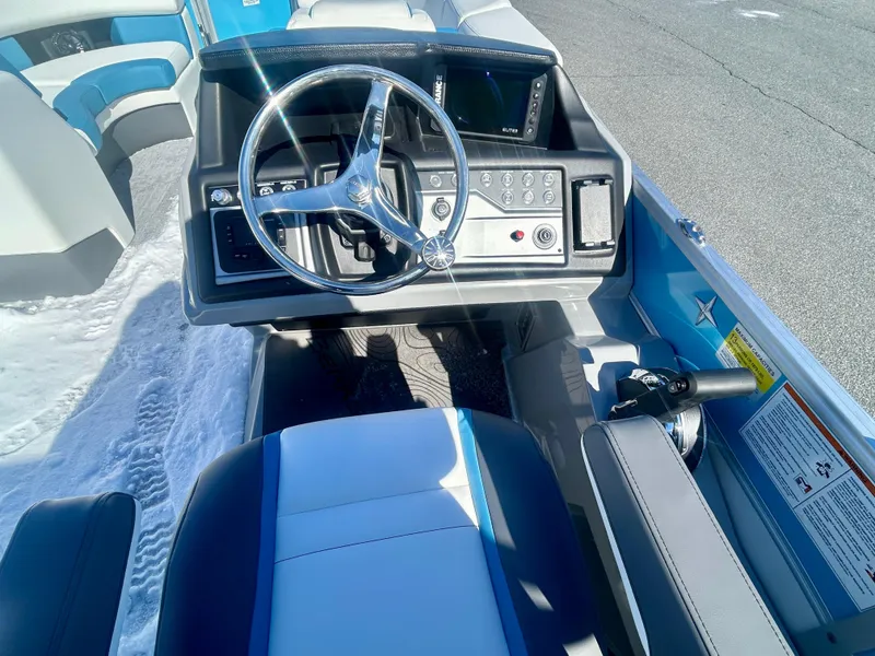 Slide: The Image of 2025 Berkshire 23RFX STS 3.0 boat interior with steering wheel and control panel. - 8