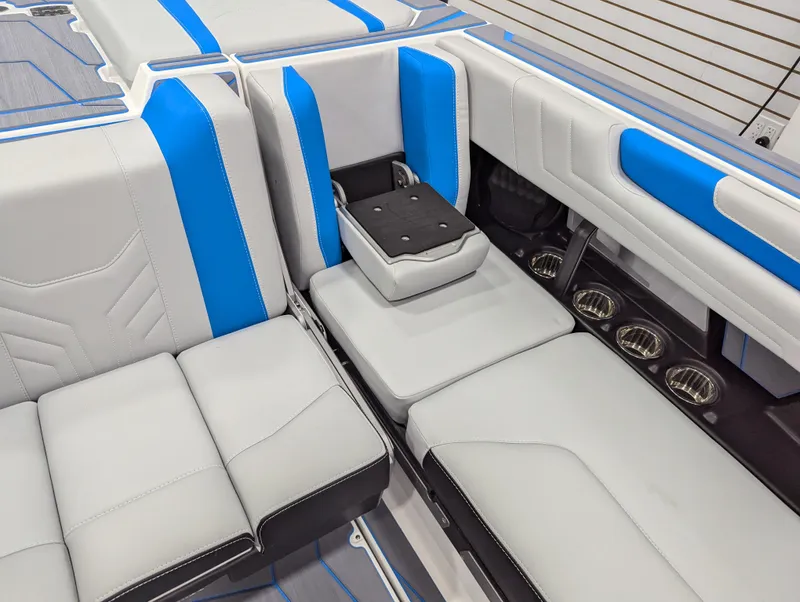 Slide: The Image of 2025 Malibu Wakesetter 25 LSV interior with blue and gray seating, showcasing modern design. - 11