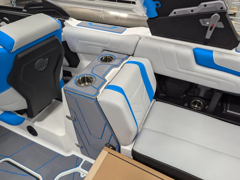 Slide: The Image of Interior of 2025 Malibu Wakesetter 25 LSV boat with blue and gray seating. - 13