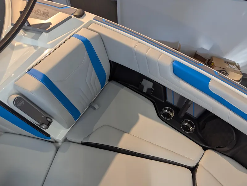 Slide: The Image of 2025 Malibu Wakesetter 25 LSV interior with blue and white seating and cup holders. - 15