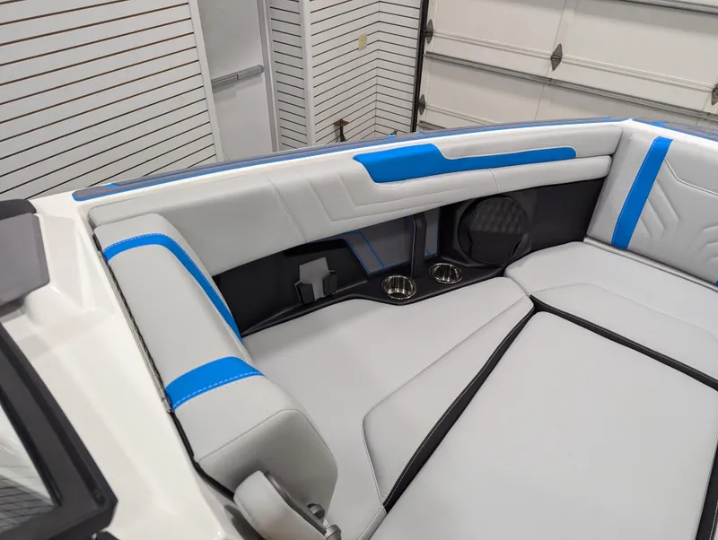 Slide: The Image of 2025 Malibu Wakesetter 25 LSV interior with sleek gray and blue seating design. - 7
