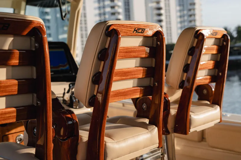 Slide: The Image of Luxury seating on 2022 HCB 53 Sueños boat with wooden accents. - 10