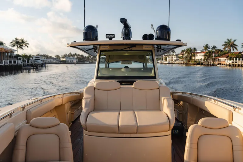 Slide: The Image of 2022 HCB 53 Sueños boat interior with luxurious seating on a calm waterway. - 13