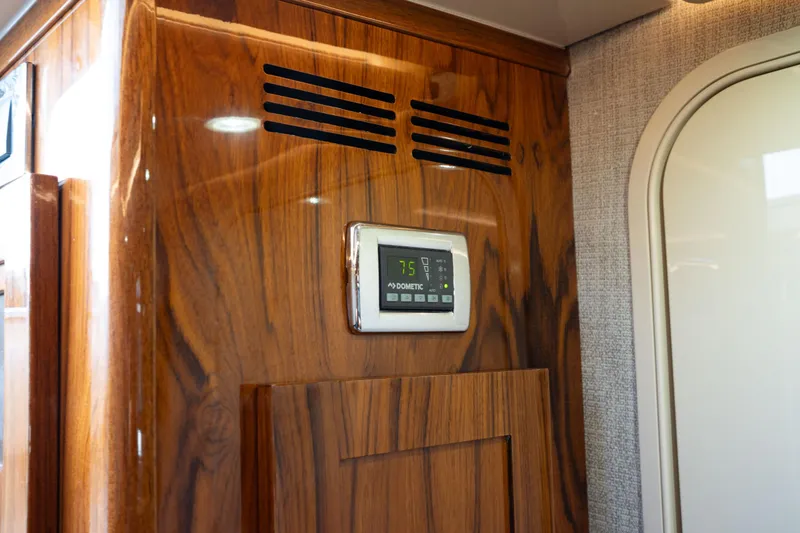 Slide: The Image of Wooden interior panel with digital control display on 2022 HCB 53 Sueños boat. - 20