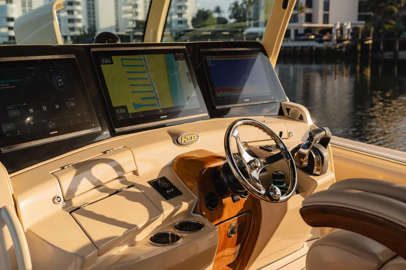 Slide: The Image of Helm of 2022 HCB 53 Sueños boat with modern navigation screens and steering wheel. - 21