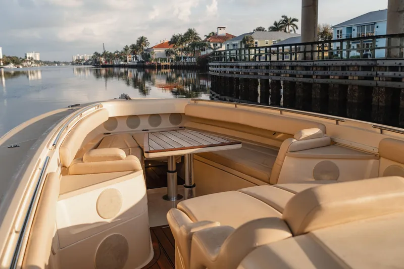 Slide: The Image of Luxurious seating area on 2022 HCB 53 Sueños boat, docked by waterfront homes. - 26