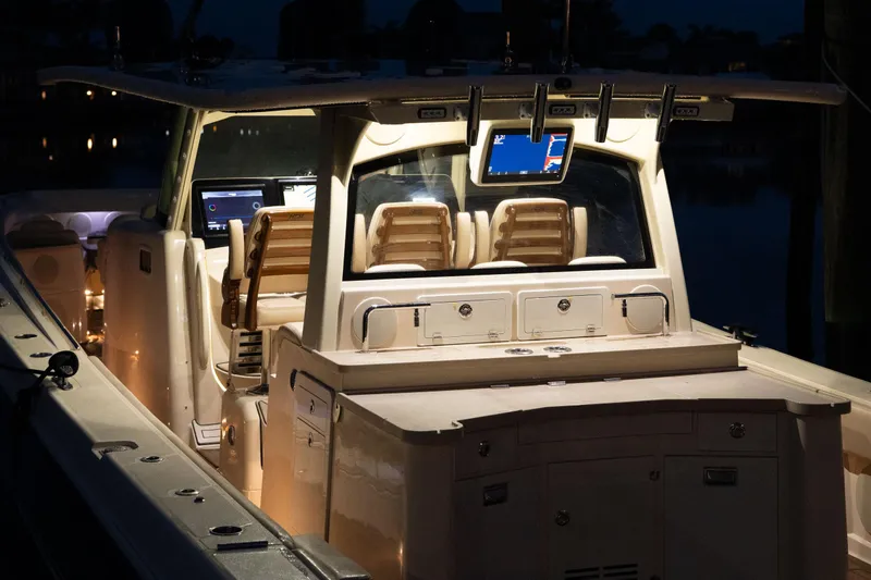 Slide: The Image of 2022 HCB 53 Sueños boat interior with illuminated dashboard and seating. - 3