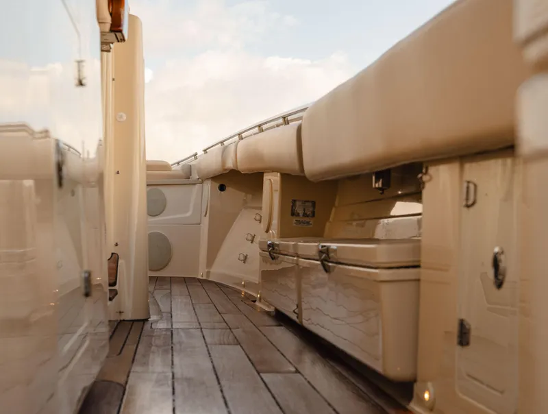 Slide: The Image of 2022 HCB 53 Sueños boat interior with wooden deck and beige seating. - 31