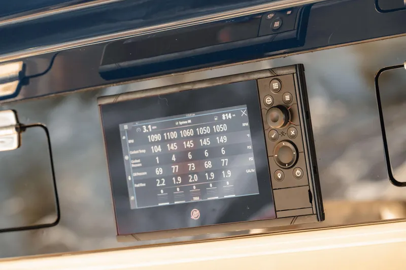 Slide: The Image of Control panel of 2022 HCB 53 Sueños boat, featuring digital display and navigation controls. - 32