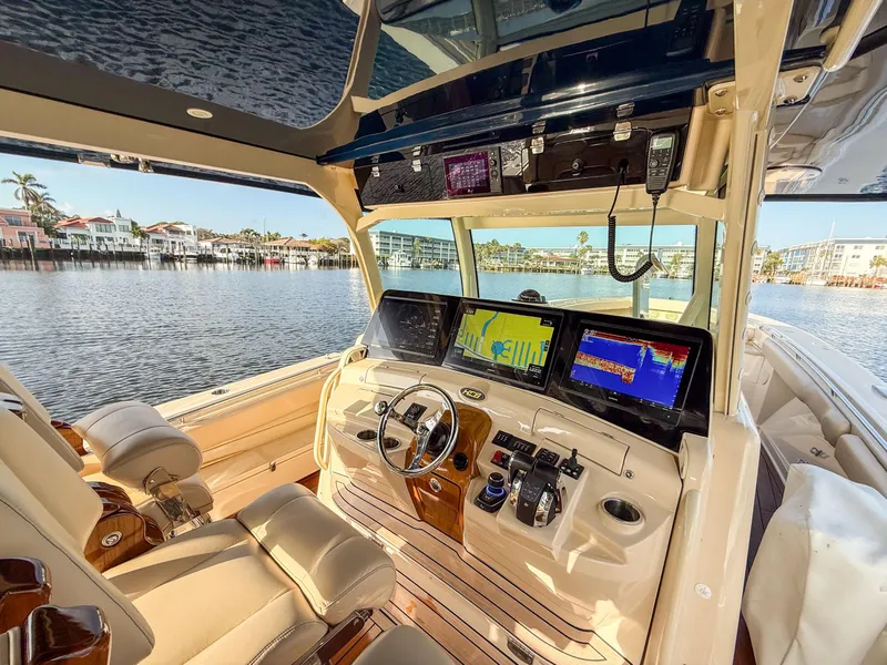 Slide: The Image of 2022 HCB 53 Sueños boat cockpit with advanced navigation displays and luxurious seating. - 34