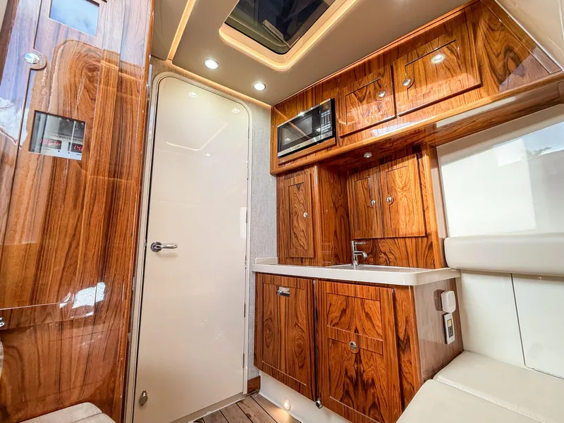 Slide: The Image of Luxurious interior of 2022 HCB 53 Sueños with wood cabinetry and modern amenities. - 36