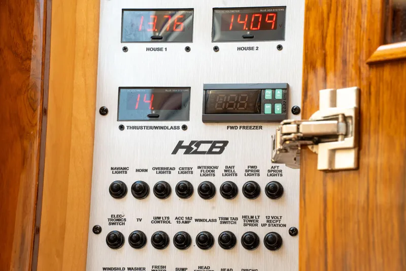 Slide: The Image of Control panel of 2022 HCB 53 Sueños boat with various switches and digital displays. - 37
