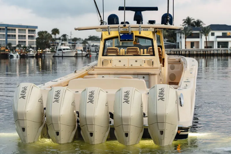 Slide: The Image of 2022 HCB 53 Sueños boat with five powerful outboard engines docked in marina. - 8