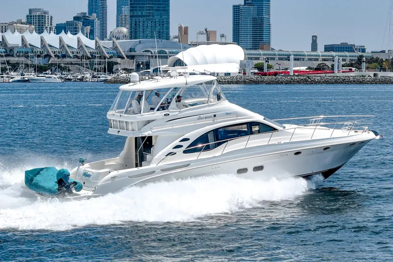 Slide: The Image of 2008 Sea Ray 58 Sedan Bridge yacht cruising in urban waterfront setting. - 0
