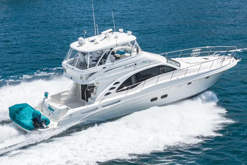 Slide: The Image of 2008 Sea Ray 58 Sedan Bridge yacht cruising on open water. - 1