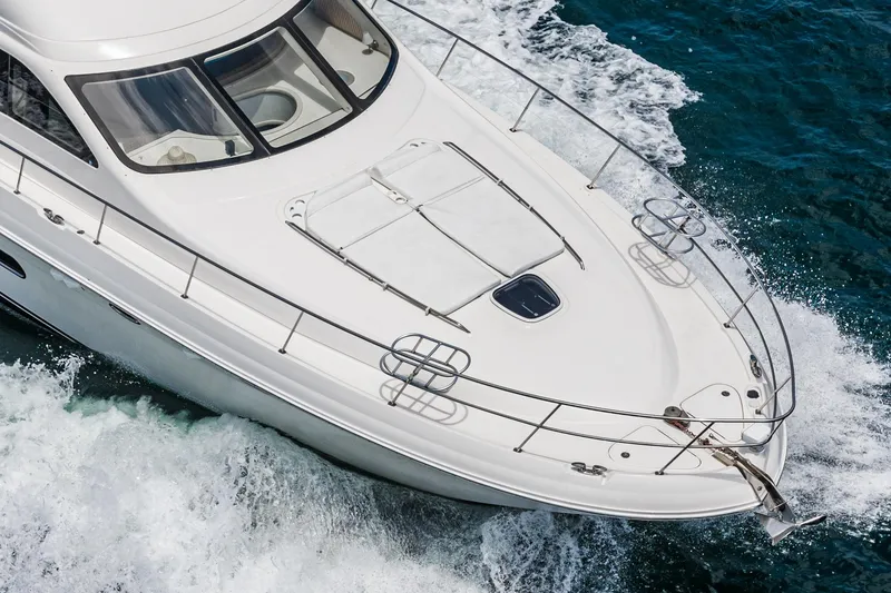 Slide: The Image of 2008 Sea Ray 58 Sedan Bridge yacht cruising on ocean waves. - 11