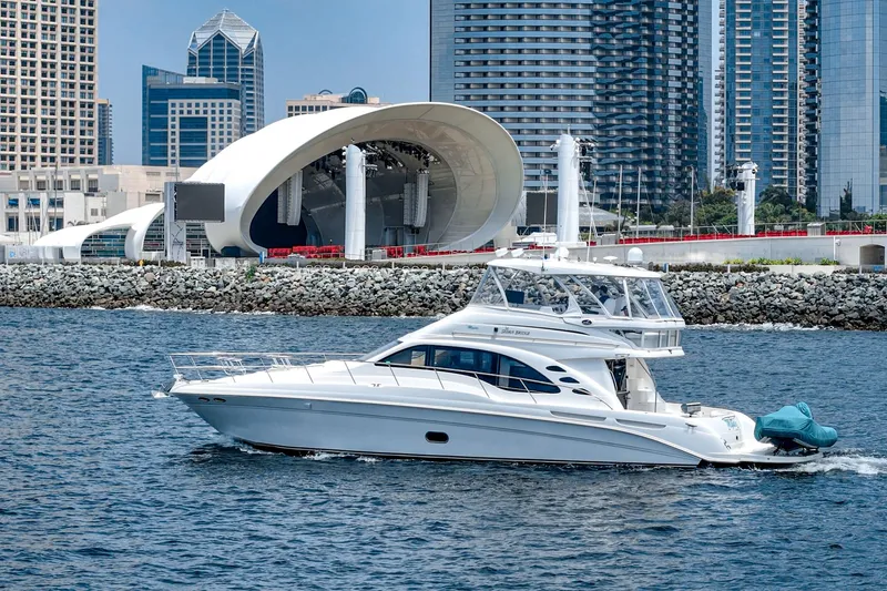 Slide: The Image of 2008 Sea Ray 58 Sedan Bridge yacht cruising near urban waterfront skyline. - 12