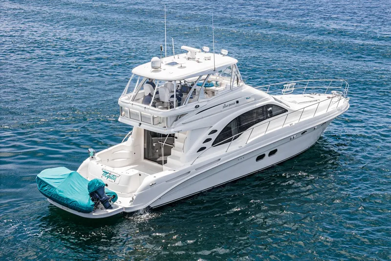 Slide: The Image of 2008 Sea Ray 58 Sedan Bridge yacht cruising on clear blue water. - 14