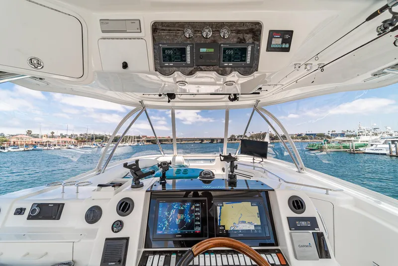 Slide: The Image of 2008 Sea Ray 58 Sedan Bridge helm with navigation screens and ocean view. - 15