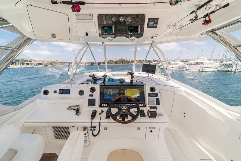 Slide: The Image of 2008 Sea Ray 58 Sedan Bridge helm with advanced navigation systems and marina view. - 16