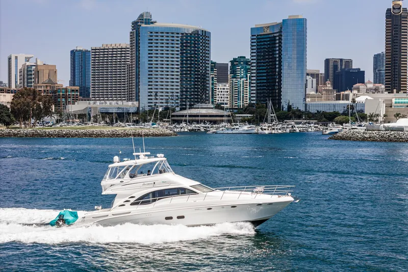 Slide: The Image of 2008 Sea Ray 58 Sedan Bridge yacht cruising near city skyline. - 2
