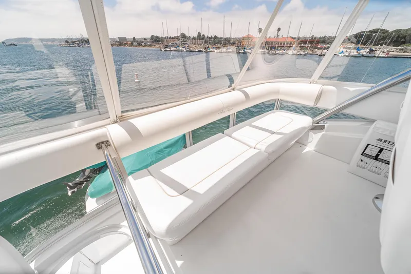 Slide: The Image of 2008 Sea Ray 58 Sedan Bridge yacht interior with white seating and ocean view. - 20