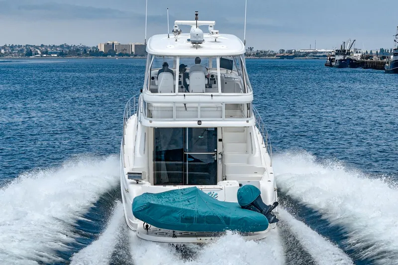 Slide: The Image of 2008 Sea Ray 58 Sedan Bridge yacht cruising on open water, rear view. - 22