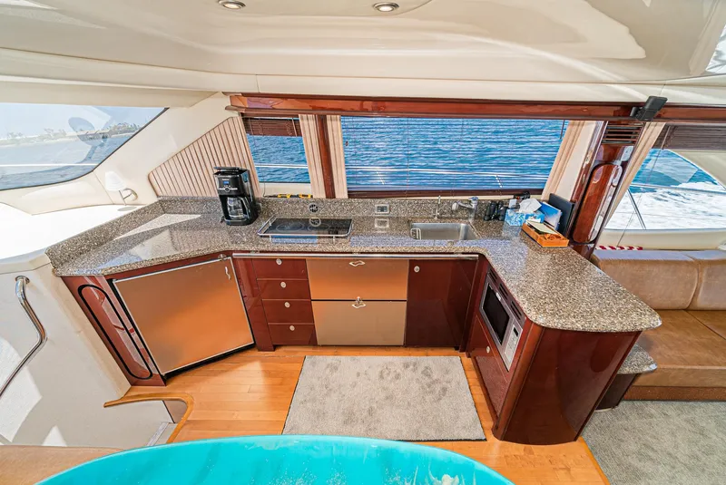 Slide: The Image of Luxurious kitchen interior of 2008 Sea Ray 58 Sedan Bridge yacht with ocean view. - 28