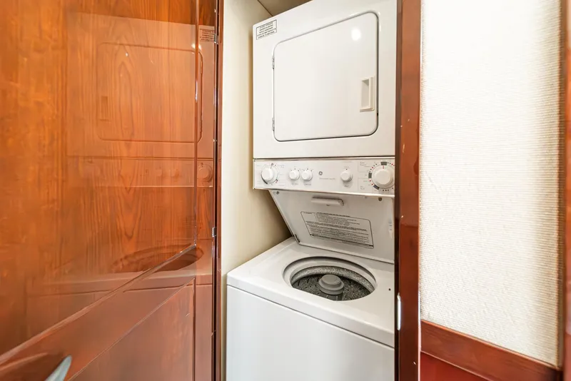 Slide: The Image of Laundry area with stacked washer and dryer in 2008 Sea Ray 58 Sedan Bridge yacht. - 40