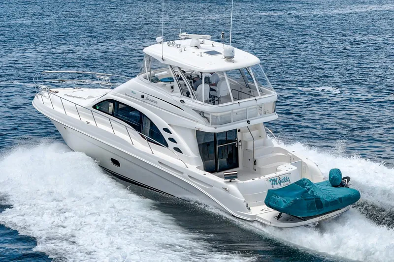 Slide: The Image of 2008 Sea Ray 58 Sedan Bridge yacht cruising on open water. - 7
