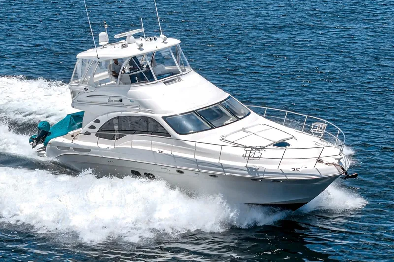 Slide: The Image of 2008 Sea Ray 58 Sedan Bridge yacht cruising on open water. - 9