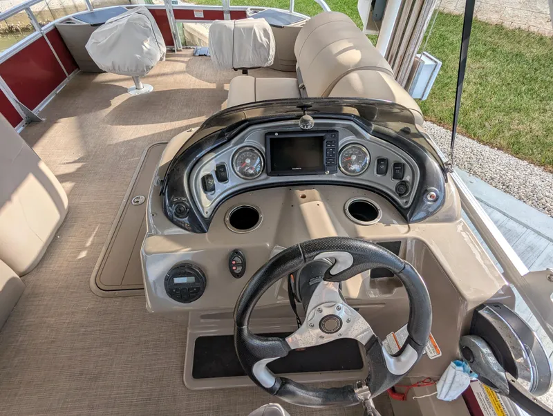 Slide: The Image of 2021 Sun Tracker Fishin' Barge 22 DLX interior with steering console and seating. - 6