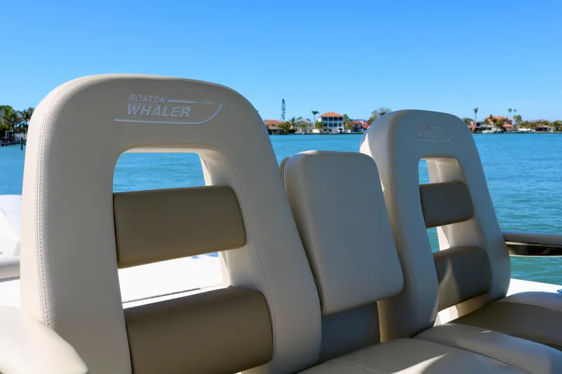 Slide: The Image of Boston Whaler 330 Outrage 2022 boat seats with waterfront view. - 25