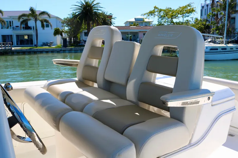Slide: The Image of 2022 Boston Whaler 330 Outrage boat seats, luxurious design, waterfront view. - 26