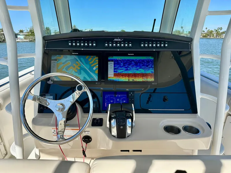 Slide: The Image of 2022 Boston Whaler 330 Outrage helm with advanced navigation displays and controls. - 27