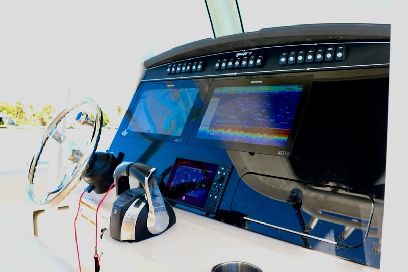Slide: The Image of Control panel of 2022 Boston Whaler 330 Outrage with advanced navigation displays. - 28