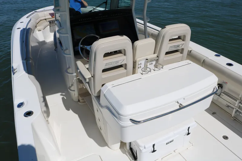 Slide: The Image of 2022 Boston Whaler 330 Outrage boat interior with helm and seating. - 31