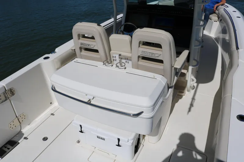 Slide: The Image of 2022 Boston Whaler 330 Outrage boat interior with seating and storage. - 32