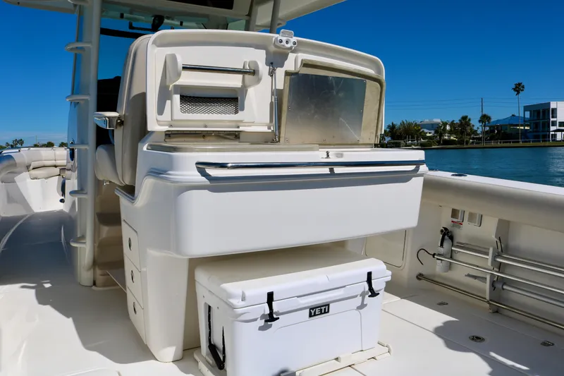 Slide: The Image of Boston Whaler 330 Outrage 2022 boat interior with Yeti cooler on deck. - 33