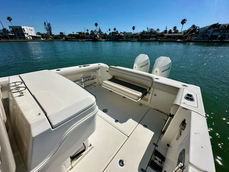 Slide: The Image of 2022 Boston Whaler 330 Outrage boat with dual engines on a sunny waterfront. - 35
