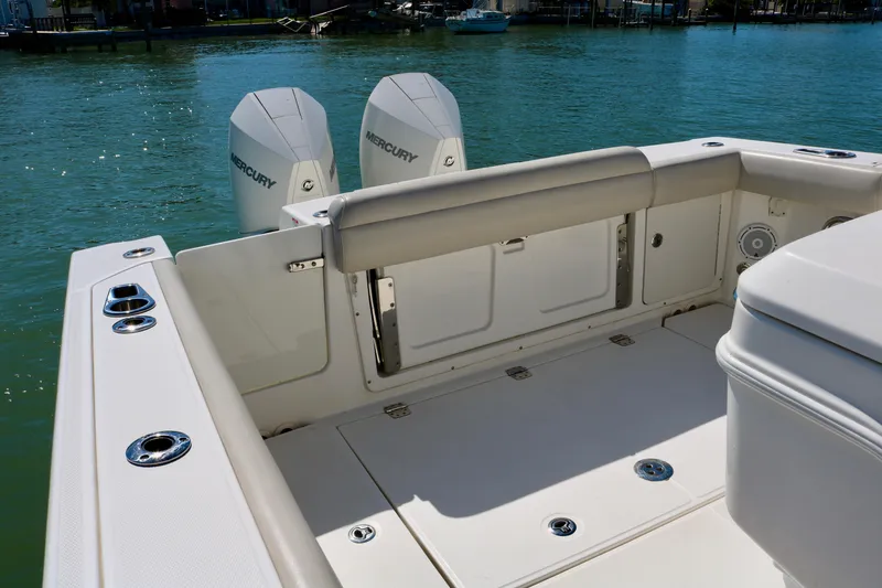 Slide: The Image of 2022 Boston Whaler 330 Outrage boat deck with twin Mercury engines. - 36