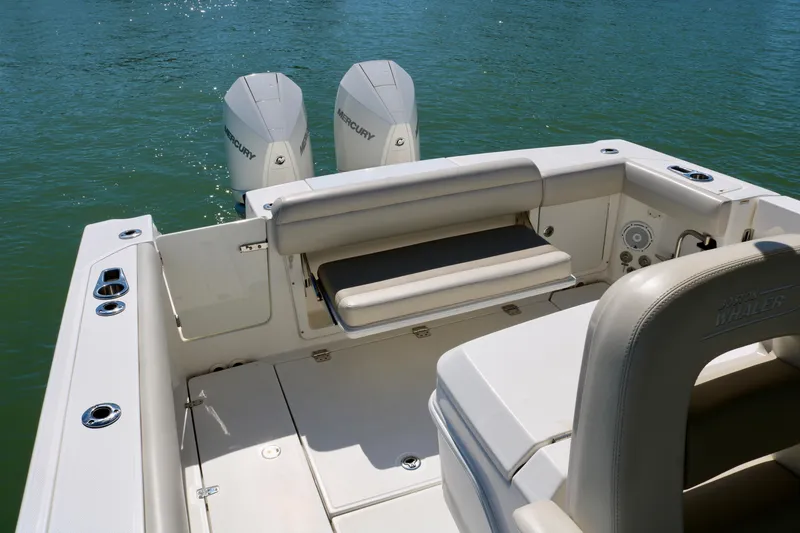 Slide: The Image of 2022 Boston Whaler 330 Outrage boat with dual Mercury engines on calm water. - 37