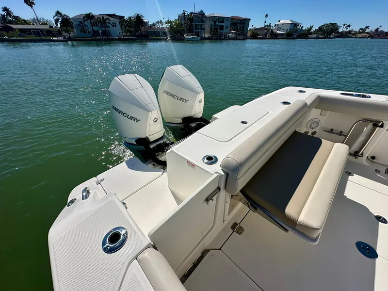 Slide: The Image of 2022 Boston Whaler 330 Outrage with dual Mercury engines on calm water. - 38