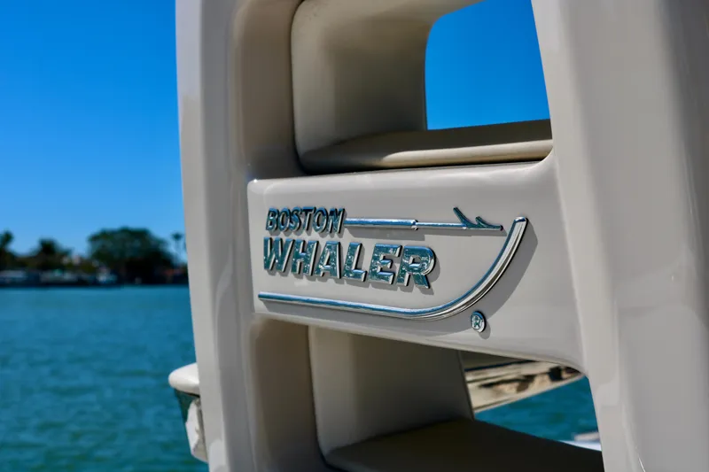 Slide: The Image of 2022 Boston Whaler 330 Outrage logo on boat, with water in the background. - 42