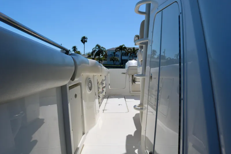 Slide: The Image of 2022 Boston Whaler 330 Outrage boat deck with palm trees in background. - 45